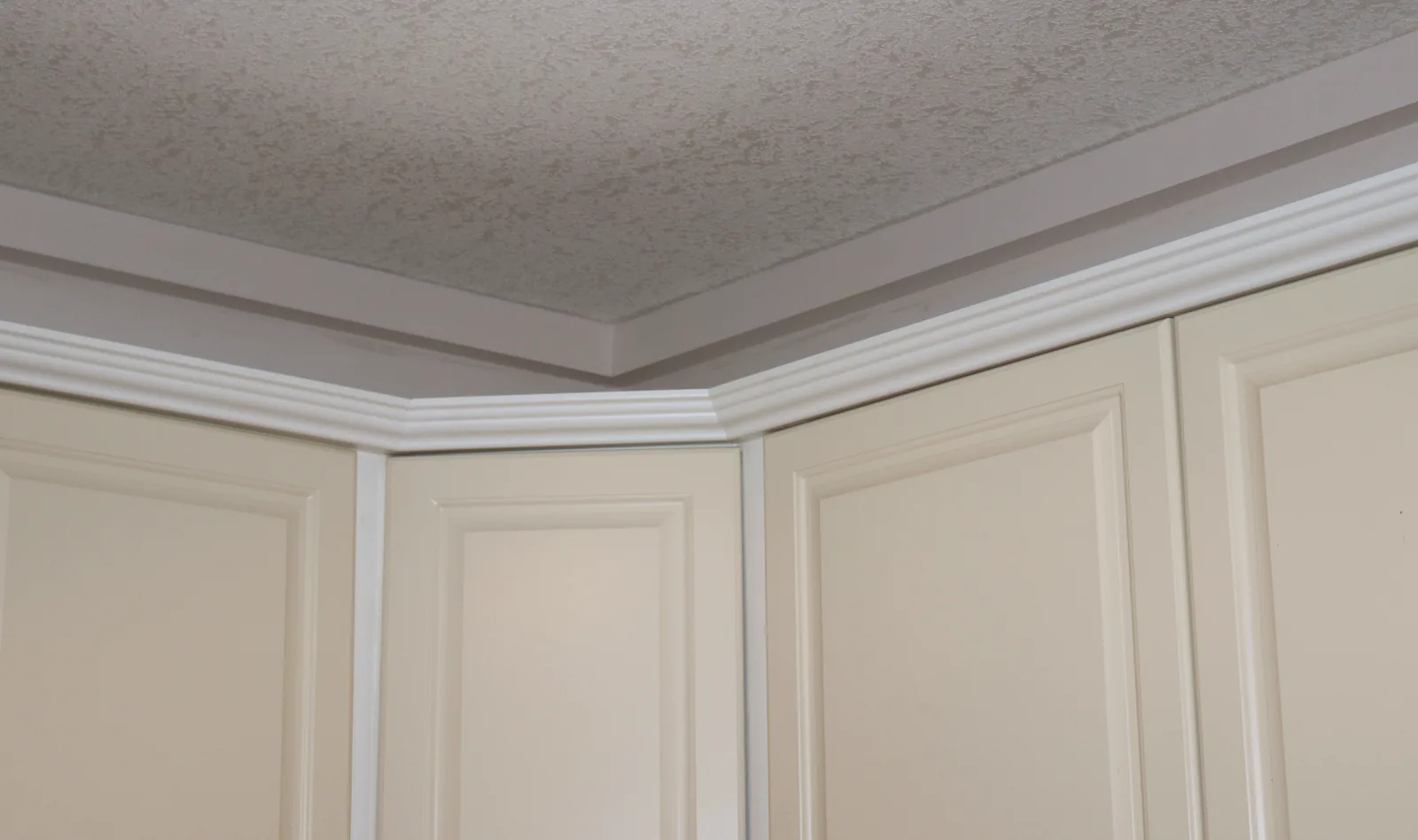 Finished Plumbing Track enclosure integrated along a room edge